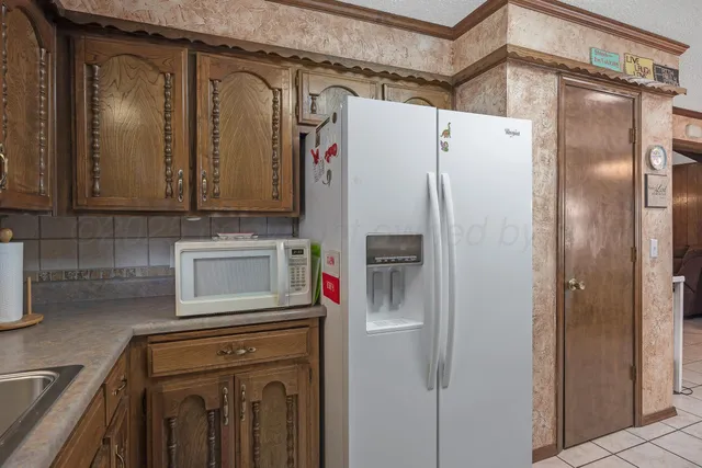 a kitchen with stainless steel appliances a refrigerator and a sink