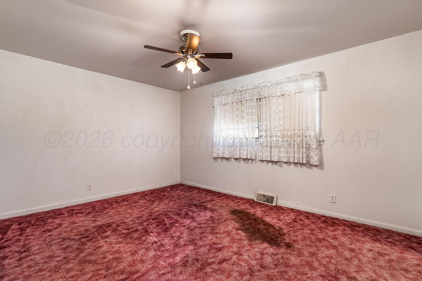 300 Mccarthy Street Borger, TX 79007 - Photo 18 of 31 an empty room with windows and fan