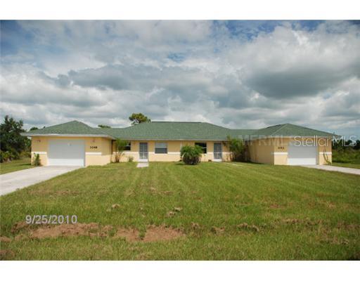 1048 Bismarck Road Punta Gorda, FL 33983 - Photo 1 of 1 a front view of a house with a garden