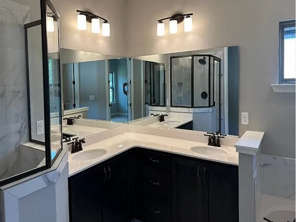 a bathroom with a double vanity sink and mirror