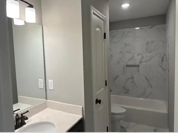 a bathroom with a bathtub and a shower