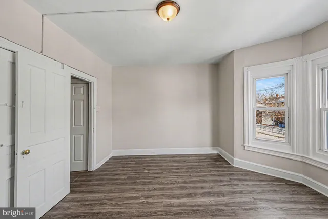 a view of room with window and hardwood floor