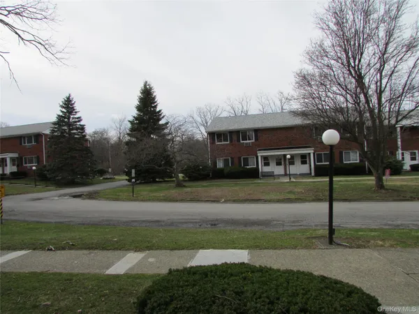 a view of a house next to a yard