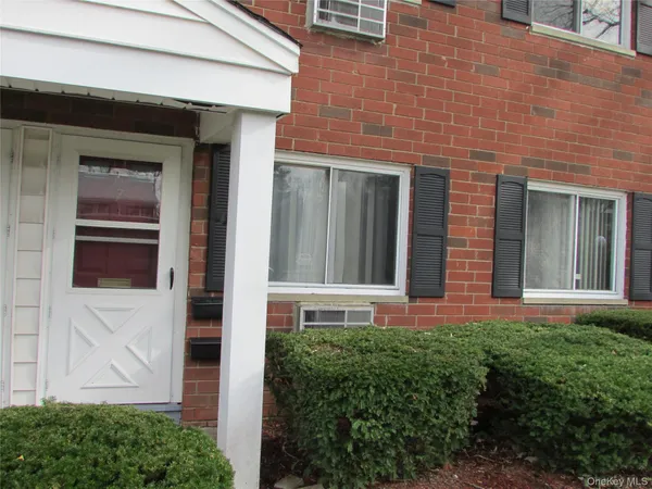 a view of a brick house with a large windows