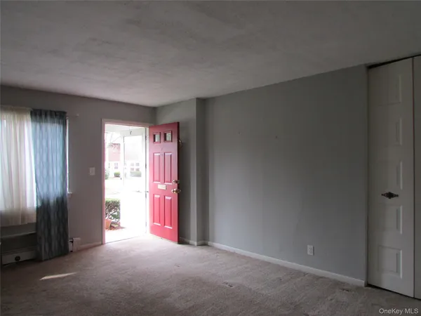 an empty room with windows and closet