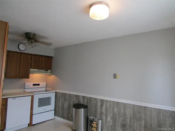 a kitchen with a refrigerator and a stove top oven