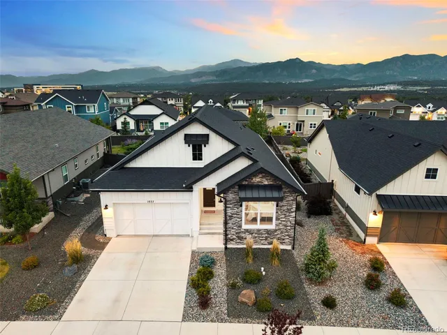 an aerial view of a house with a yard