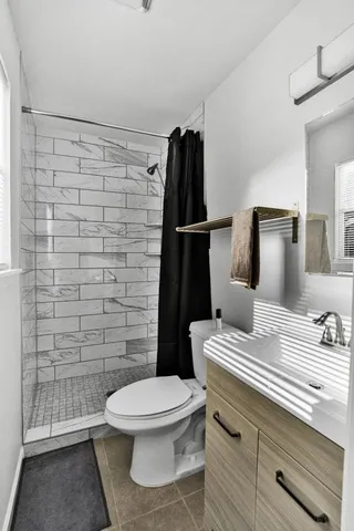 a bathroom with a toilet and a shower