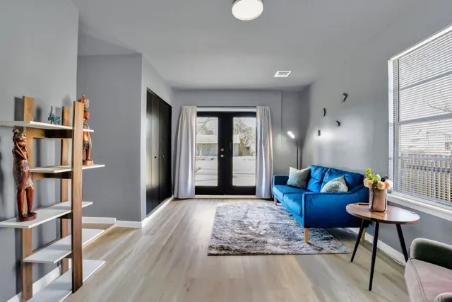 a living room with furniture and a book shelf