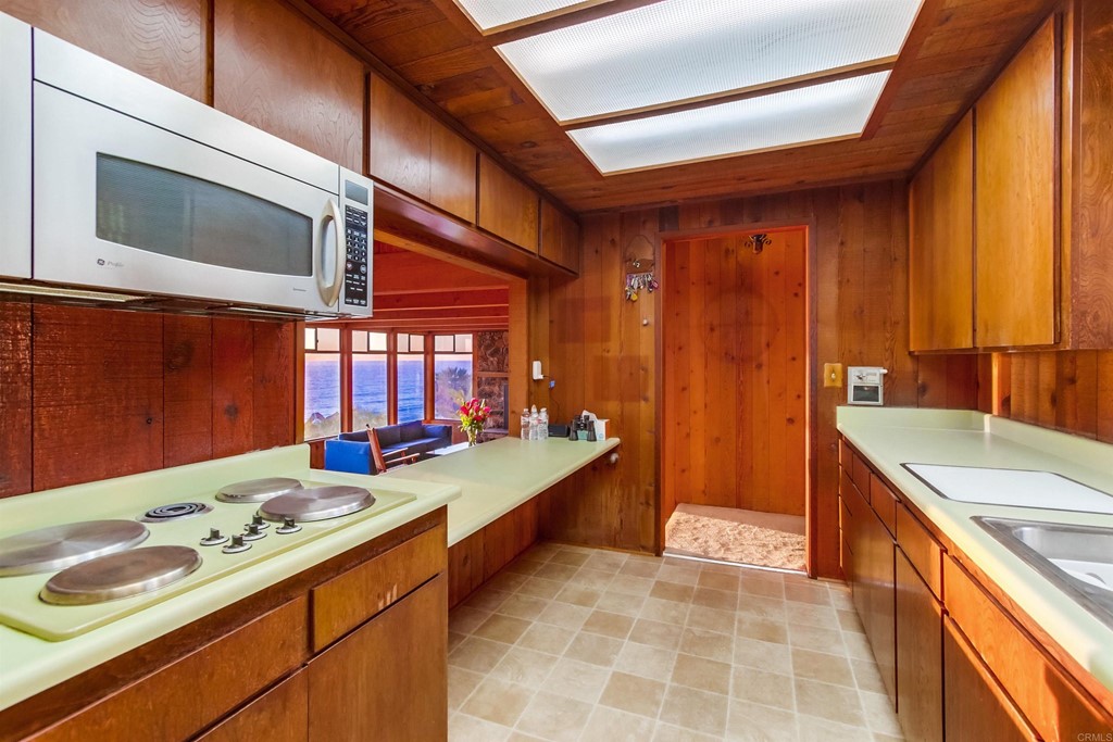 1236 Neptune Avenue Encinitas, CA 92024 - Photo 12 of 40 a kitchen that has a sink and a stove in it