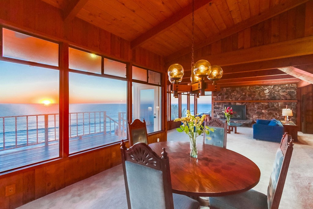 1236 Neptune Avenue Encinitas, CA 92024 - Photo 14 of 40 a dining room with furniture and a floor to ceiling window