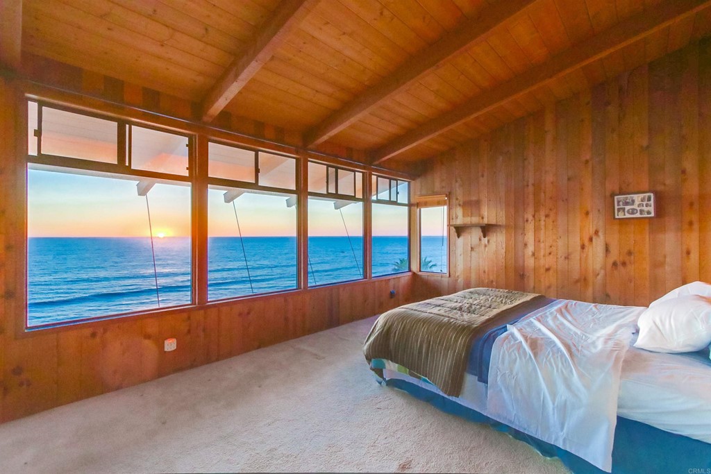 1236 Neptune Avenue Encinitas, CA 92024 - Photo 17 of 40 a bedroom with a large bed and a large window