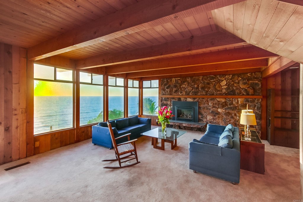 1236 Neptune Avenue Encinitas, CA 92024 - Photo 9 of 40 a living room with furniture a flat screen tv and floor to ceiling window