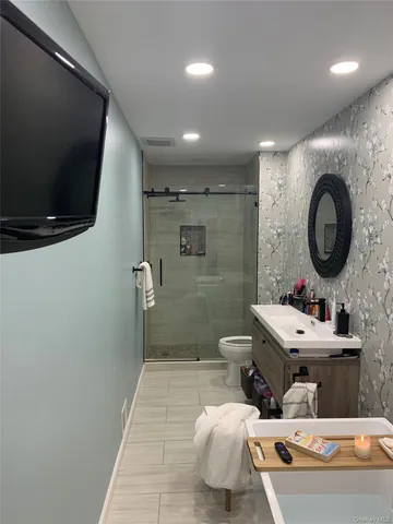 a bathroom with a sink a mirror and a toilet