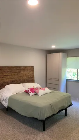 a bedroom with a bed and window