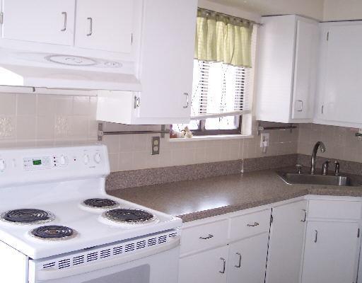 7 Arch Street, Unit 22 Norwalk, CT 06850 - Photo 1 of 1 a kitchen with a stove a sink and a cabinets
