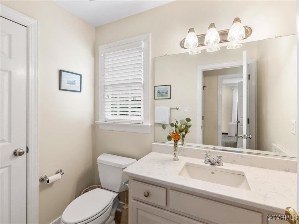 8104 Lower Ralston Road Henrico, VA 23229 - Photo 25 of 49 a bathroom with a sink a toilet and a mirror
