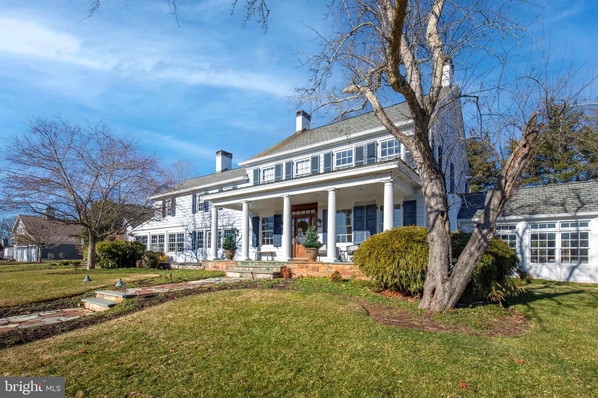 a view of a house with a yard patio and fire pit