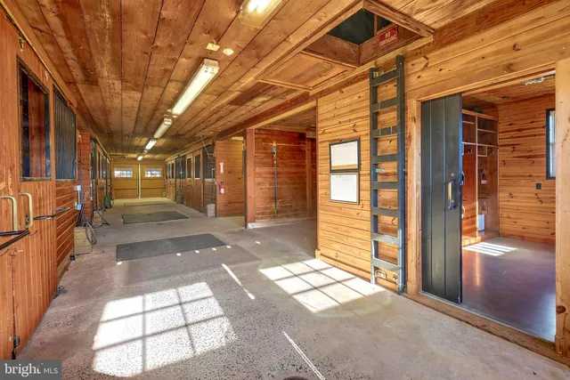 a view of a kitchen with stainless steel appliances wooden cabinets and a stove top oven
