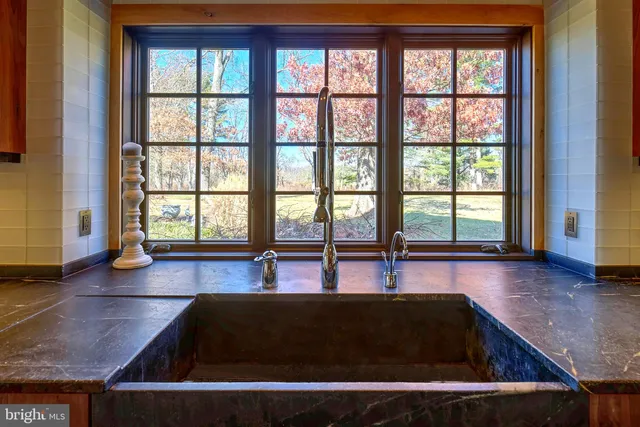 a swimming pool view with a floor to ceiling window and wooden floor