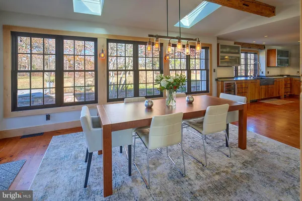 a dining room with furniture a chandelier and wooden floor