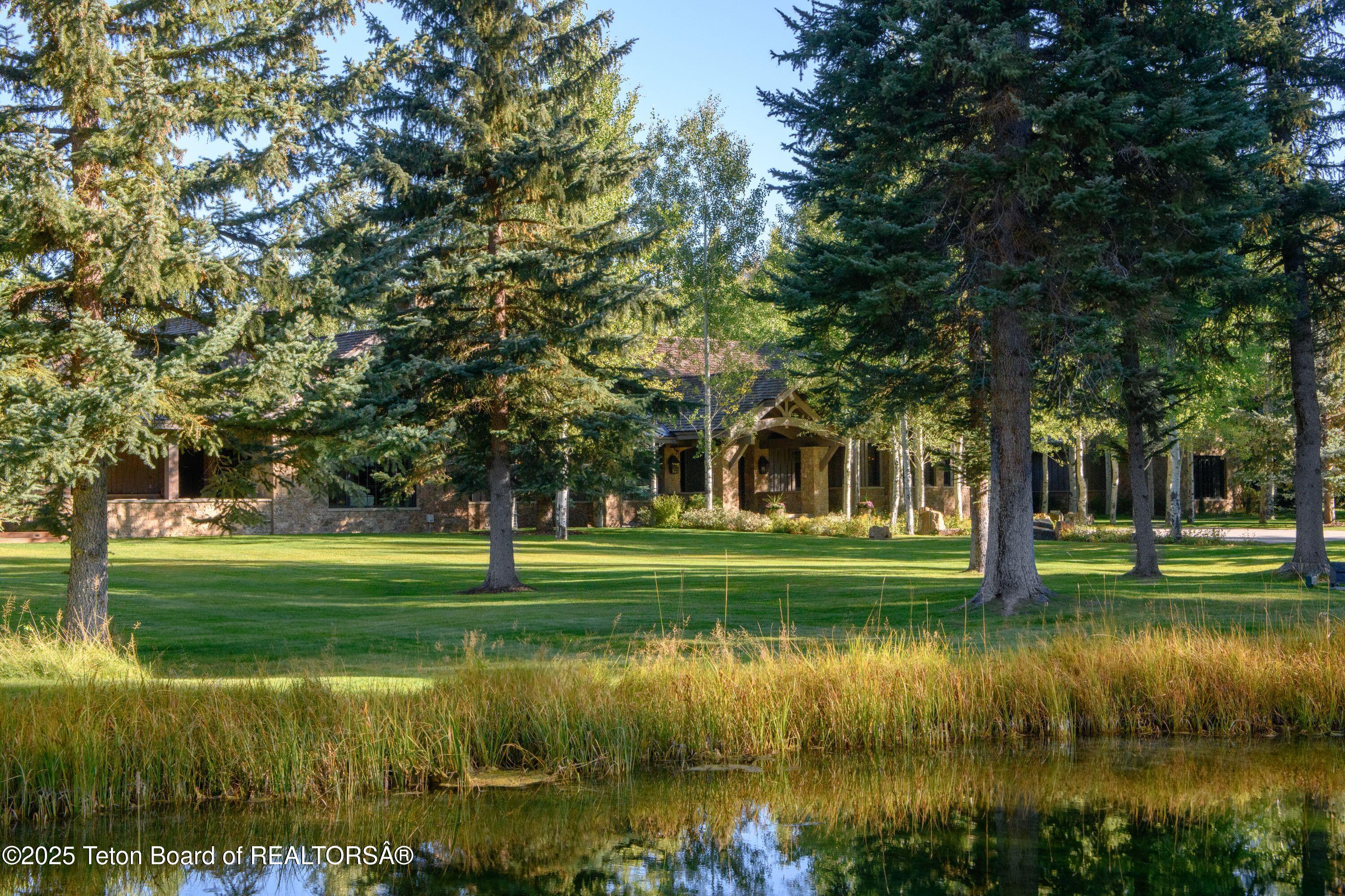 7555-7565 North Bar B Bar River Road Jackson, WY 83001 - Photo 31 of 59 Front view w/ Pond
