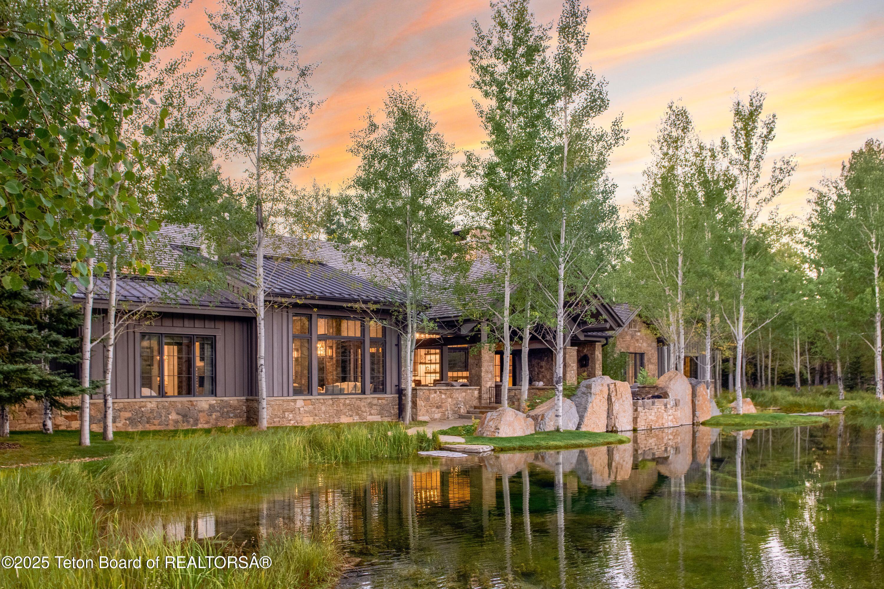 7555-7565 North Bar B Bar River Road Jackson, WY 83001 - Photo 34 of 59 Back of home w/ Pond views