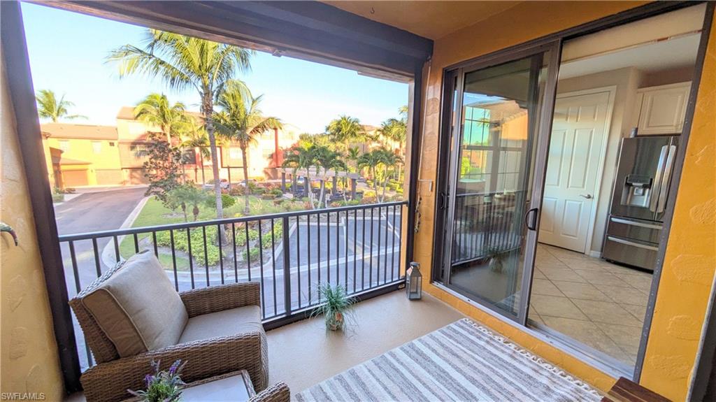 9063 Capistrano Street North, Unit 4408 Naples, FL 34113 - Photo 48 of 50 a view of a porch with wooden floor and furniture