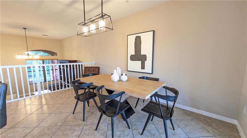 9063 Capistrano Street North, Unit 4408 Naples, FL 34113 - Photo 13 of 50 a view of a dining room with furniture and chandelier