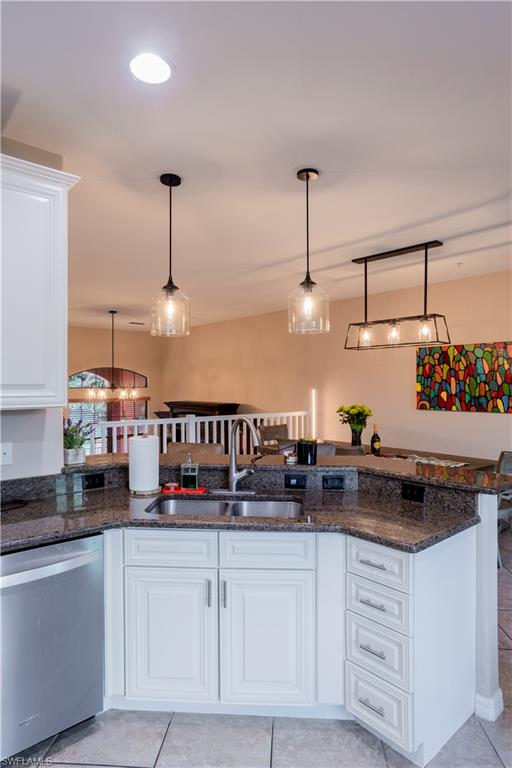9063 Capistrano Street North, Unit 4408 Naples, FL 34113 - Photo 50 of 50 a kitchen with stainless steel appliances granite countertop a sink and a white cabinets
