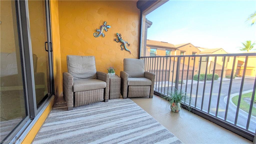 9063 Capistrano Street North, Unit 4408 Naples, FL 34113 - Photo 16 of 50 a view of a balcony with furniture