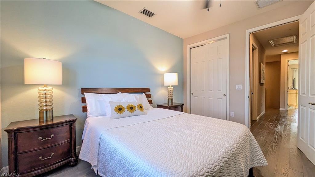 9063 Capistrano Street North, Unit 4408 Naples, FL 34113 - Photo 22 of 50 a bedroom with a bed and a night stand