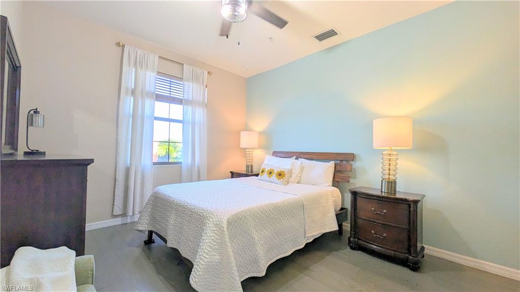 9063 Capistrano Street North, Unit 4408 Naples, FL 34113 - Photo 23 of 50 a bedroom with a bed and a window