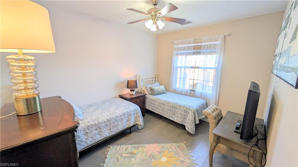9063 Capistrano Street North, Unit 4408 Naples, FL 34113 - Photo 25 of 50 a bedroom with bed a window and a flat screen tv