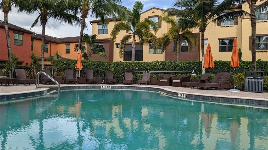 9063 Capistrano Street North, Unit 4408 Naples, FL 34113 - Photo 31 of 50 a front view of a house with swimming pool