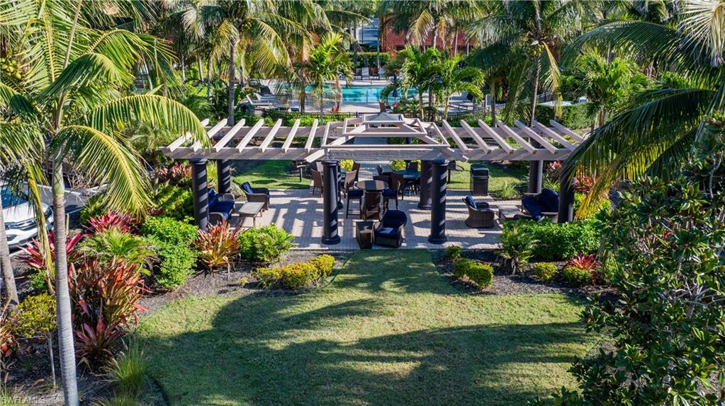 9063 Capistrano Street North, Unit 4408 Naples, FL 34113 - Photo 34 of 50 a view of swimming pool with a patio and garden