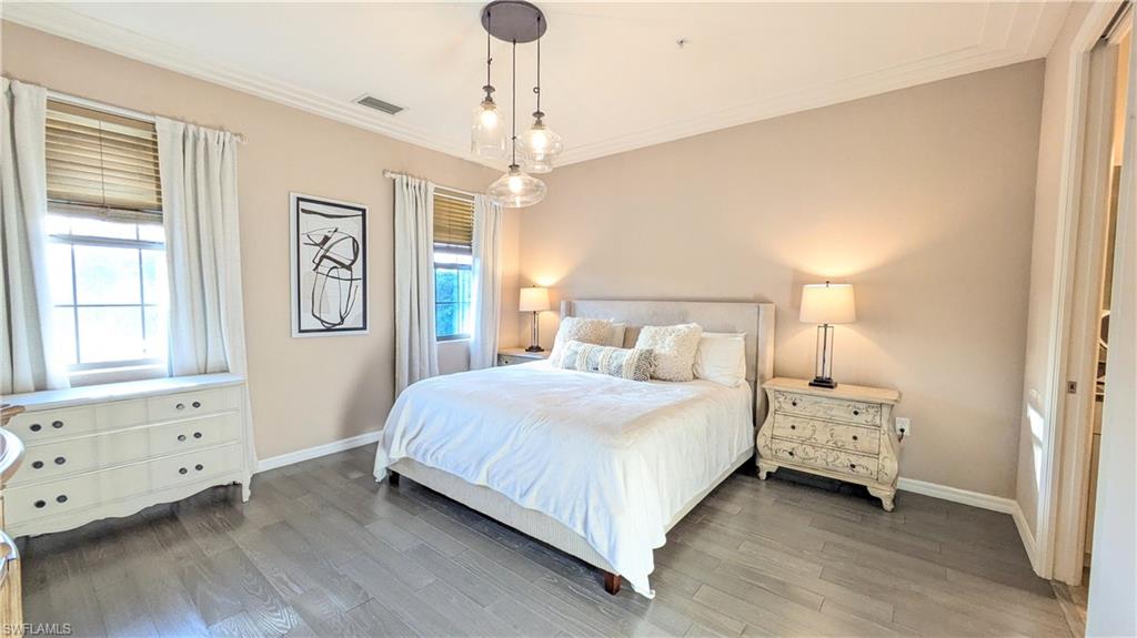 9063 Capistrano Street North, Unit 4408 Naples, FL 34113 - Photo 5 of 50 a bedroom with a bed and a window
