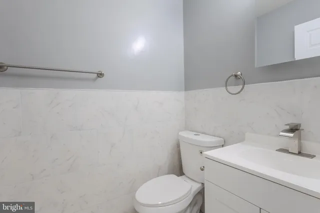 a white toilet sitting next to a bathroom sink