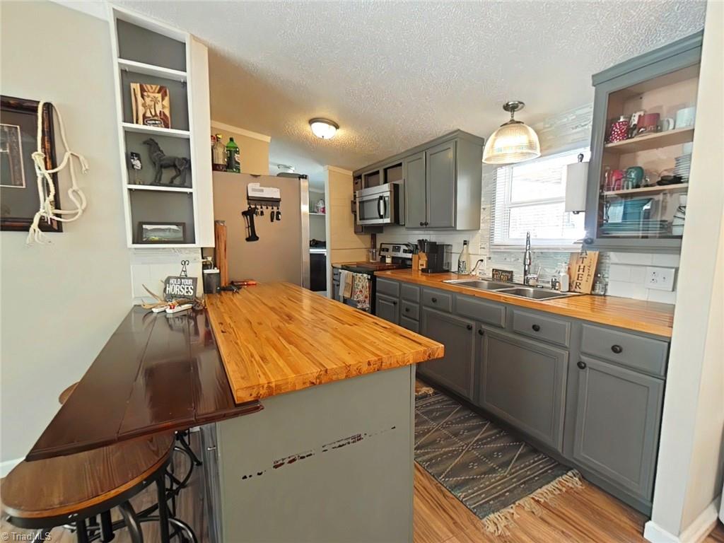 4766 Kennedy Road Trinity, NC 27370 - Photo 5 of 32 Tastefully decorated kitchen with stainless appliances and eating bar
