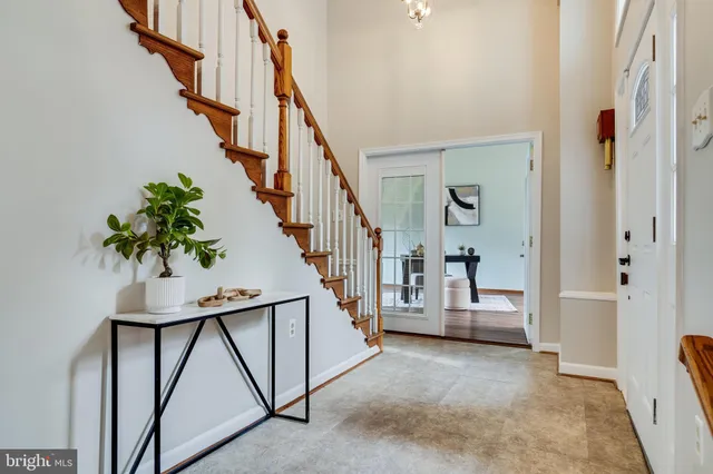 a view of entryway with wooden floor and stairs