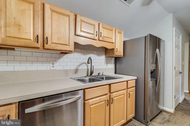 a view of an empty room with a chandelier fan