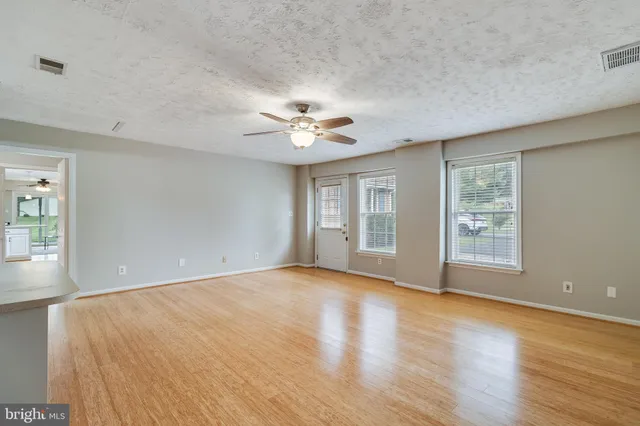 an empty room with a empty space and windows