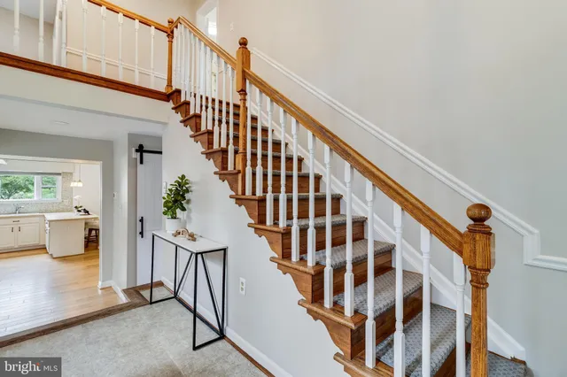 a view of entryway with wooden floor and windows