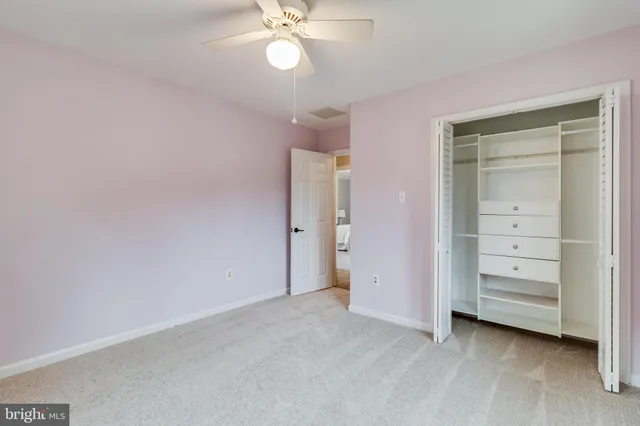 a white house that has tree in front of it