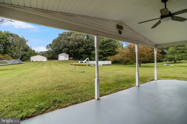an aerial view of residential houses with outdoor space and trees all around