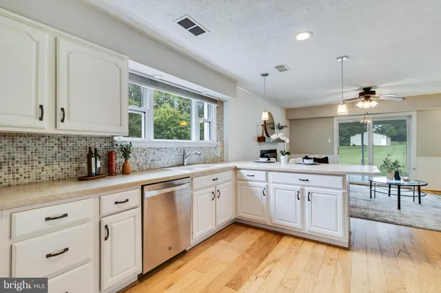 a kitchen with stainless steel appliances a stove a refrigerator and a microwave