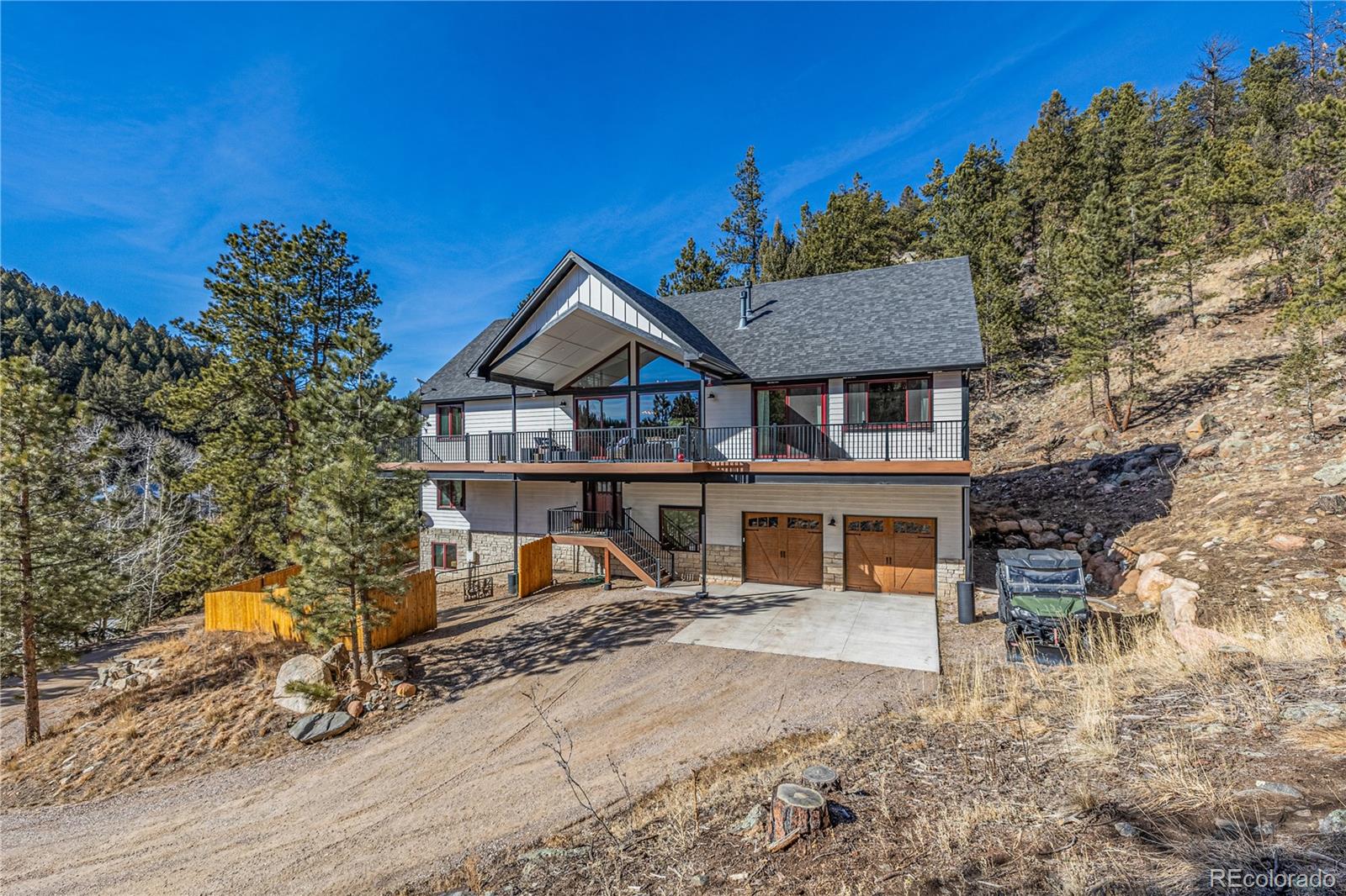 663 Brookside Drive Bailey, CO 80421 - Photo 1 of 47 a front view of a house with a garden