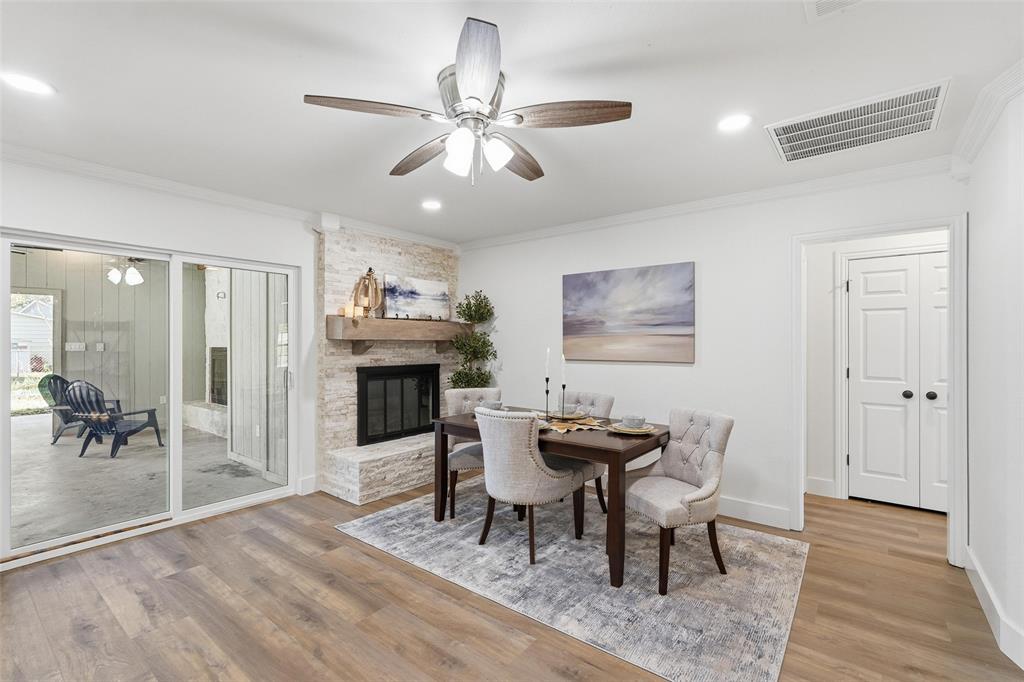 9938 John Flowers Road Wills Point, TX 75169 - Photo 21 of 40 Dining area featuring ceiling fan, light wood-style floors, a fireplace, crown molding, and recessed lighting