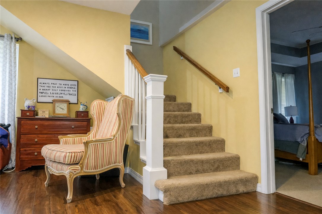 164 Park Road Russellville, AR 72802 - Photo 21 of 35 Carpeted staircase with white balusters and a wood handrail