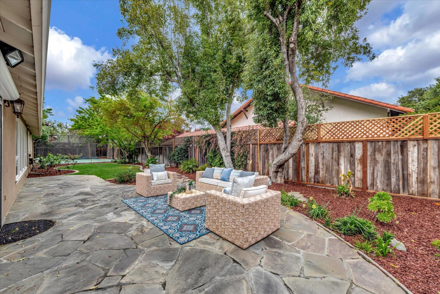 1623 Fallen Leaf Lane Los Altos, CA 94024 - Photo 52 of 62 a view of a patio with table and chairs potted plants and a large tree